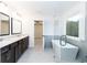 Bright bathroom featuring a standalone tub, glass shower, dual vanity, and modern fixtures at 1254 Red Oak Blvd, Loganville, GA 30052
