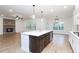 Bright kitchen with island, stainless appliances, pendant lighting, and view to living room at 1254 Red Oak Blvd, Loganville, GA 30052