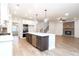 Open concept kitchen with a large island, stainless steel appliances, and an adjacent living area at 1254 Red Oak Blvd, Loganville, GA 30052