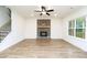 Bright living room features beautiful floors, large windows and a charming brick fireplace at 1254 Red Oak Blvd, Loganville, GA 30052