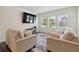 Inviting living room with comfortable sofas, large TV, and ample natural light from the windows at 2688 Toucan Way, Atlanta, GA 30331