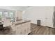 Bright open-concept living room and kitchen area, perfect for entertaining, with white walls and hardwood floors at 2688 Toucan Way, Atlanta, GA 30331