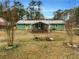 Backyard view of single story home with a large open yard and a covered patio at 9206 Carlton Nw Trl, Covington, GA 30014