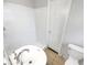 Bathroom with white tiling in the shower and a white pedestal sink and toilet at 9206 Carlton Nw Trl, Covington, GA 30014