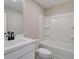 Clean bathroom with white vanity, tub shower combo, and black matte fixtures at 261 Dahlia Dr, Woodstock, GA 30188