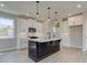 Modern kitchen with black island and white cabinets at 261 Dahlia Dr, Woodstock, GA 30188