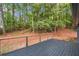 Deck with metal railing overlooking a private wooded backyard with mature trees and natural beauty at 2228 Old Dallas Sw Rd, Marietta, GA 30064