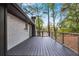 Home exterior featuring a dark wood deck, painted white brick, and a lush, wooded backyard at 2228 Old Dallas Sw Rd, Marietta, GA 30064