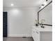 Bright bathroom featuring a white vanity, black fixtures, and large mirror at 2228 Old Dallas Sw Rd, Marietta, GA 30064