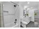 New bathroom featuring subway tile shower, vanity with dual sinks and black hardware at 2228 Old Dallas Sw Rd, Marietta, GA 30064