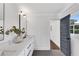 Bright bathroom featuring double sinks, a large mirror, and a blue paneled door at 2228 Old Dallas Sw Rd, Marietta, GA 30064