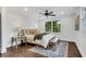 Bright bedroom features hardwood floors, a ceiling fan, and a large window providing natural light at 2228 Old Dallas Sw Rd, Marietta, GA 30064