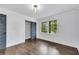Bright empty room features hardwood floors, white walls, and a large window overlooking greenery at 2228 Old Dallas Sw Rd, Marietta, GA 30064