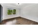 Bright empty room features hardwood floors, white walls, and a large window at 2228 Old Dallas Sw Rd, Marietta, GA 30064