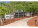 Beautiful two-story home featuring a charming front porch surrounded by lush greenery and a long driveway at 2228 Old Dallas Sw Rd, Marietta, GA 30064
