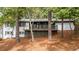 Beautiful two-story home featuring a charming front porch surrounded by lush greenery at 2228 Old Dallas Sw Rd, Marietta, GA 30064