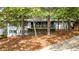 Beautiful two-story home featuring a charming front porch surrounded by lush greenery at 2228 Old Dallas Sw Rd, Marietta, GA 30064