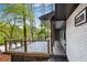 Close up of covered front porch with wood and metal railing and painted brick and siding at 2228 Old Dallas Sw Rd, Marietta, GA 30064