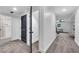 Hallway boasts neutral colors, trim detail, and dark doors leading to the bathroom and carpeted living space at 2228 Old Dallas Sw Rd, Marietta, GA 30064