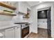 Bright kitchen features stainless steel appliances, white cabinets and decorative floating shelves at 2228 Old Dallas Sw Rd, Marietta, GA 30064