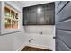 Laundry room with natural light, dark cabinets, and wooden floors at 2228 Old Dallas Sw Rd, Marietta, GA 30064