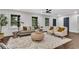Light filled living room with white walls, gray couch, two white chairs and dark wood floors at 2228 Old Dallas Sw Rd, Marietta, GA 30064