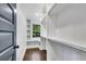 Bright walk-in closet features wood floor, white built-in shelves, and a window at 2228 Old Dallas Sw Rd, Marietta, GA 30064