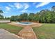 Inground pool with a wood deck, diving board, and wooded backdrop at 601 Wantland Rd, Bowdon, GA 30108