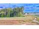 Aerial view of a serene community with lush greenery, a tranquil pond, and modern townhouses at 94 S Auburn Landing Pl, Auburn, GA 30011