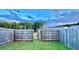 Fenced backyard with grassy area and open gate at 94 S Auburn Landing Pl, Auburn, GA 30011