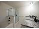 Bathroom with granite double vanity, shower, and soaking tub at 94 S Auburn Landing Pl, Auburn, GA 30011