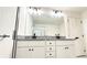 Bathroom with granite double vanity and large mirror at 94 S Auburn Landing Pl, Auburn, GA 30011