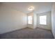 Spacious bedroom with neutral walls, carpet, and two windows at 94 S Auburn Landing Pl, Auburn, GA 30011
