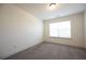 Well-lit bedroom with carpet and a window, offering a peaceful atmosphere at 94 S Auburn Landing Pl, Auburn, GA 30011