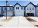 White townhome with 2-car garage and landscaping at 94 S Auburn Landing Pl, Auburn, GA 30011