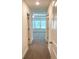 Bright hallway with carpeted floors and doors to bedrooms at 94 S Auburn Landing Pl, Auburn, GA 30011