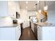 Modern kitchen with granite countertops, stainless steel appliances, and white cabinets at 94 S Auburn Landing Pl, Auburn, GA 30011