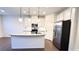 Modern kitchen with granite countertops, stainless steel appliances, and white cabinets at 94 S Auburn Landing Pl, Auburn, GA 30011