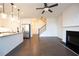 Open concept living room features hardwood floors, fireplace and kitchen access at 94 S Auburn Landing Pl, Auburn, GA 30011