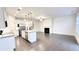 Open concept living room with hardwood floors, fireplace, and access to kitchen at 94 S Auburn Landing Pl, Auburn, GA 30011