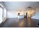 Open concept living area with hardwood floors, fireplace and kitchen view at 94 S Auburn Landing Pl, Auburn, GA 30011