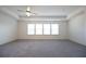 Spacious main bedroom with carpeted floor, ceiling fan, and large windows at 94 S Auburn Landing Pl, Auburn, GA 30011
