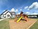 Community playground with playset and clubhouse in the background at 94 S Auburn Landing Pl, Auburn, GA 30011