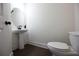 Powder room features a round mirror and dark accents at 94 S Auburn Landing Pl, Auburn, GA 30011