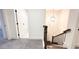 Upstairs hallway with carpet, light paint, and access to bedrooms at 94 S Auburn Landing Pl, Auburn, GA 30011