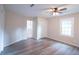 Bright bedroom with ceiling fan, wood-look vinyl flooring, and a closet at 3423 Glen Rd, Decatur, GA 30032