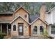 Charming townhouse featuring a stone facade and wood accents, complemented by black trim windows and a matching front door at 840 Brandy Oaks Ln, Stone Mountain, GA 30088