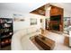 Stylish living room featuring a stone fireplace, modern sectional sofa, and a striking vaulted ceiling with an upper level loft at 840 Brandy Oaks Ln, Stone Mountain, GA 30088