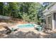 Relaxing backyard with a kidney shaped pool, lounge chairs, patio, and privacy fence at 1210 Swan Mill Ct, Suwanee, GA 30024