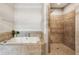Bathroom boasts a soaking tub next to a tiled walk-in shower with tiled surround at 1210 Swan Mill Ct, Suwanee, GA 30024